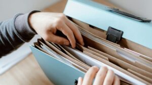 Person Going Through File Folder