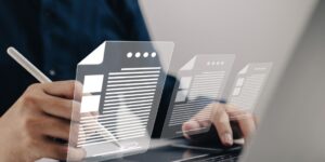 Person Working on Laptop with Document Graphics