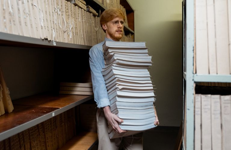 Man Holding a Stack of Documents