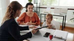 Social Worker Talking to Mother and Daughter