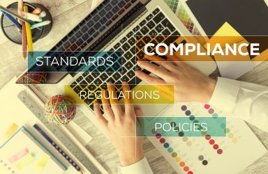 Person on a Laptop with Compliance Graphics and Text