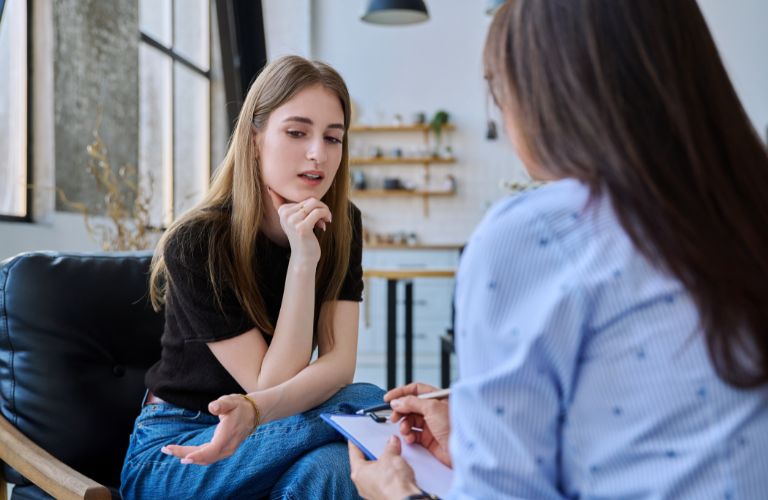 Woman Social Workers Speaking with Young Woman
