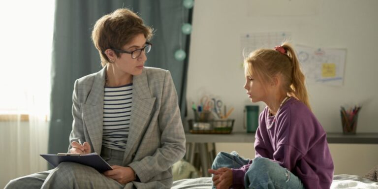 Woman Social Worker Speaking with Child